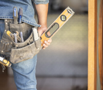 Maintenance man, bag and tools with space, mockup and home improvement service for property industr.